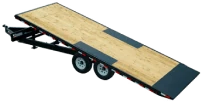 Tilt deck trailer with tandem axles and wooden platform.